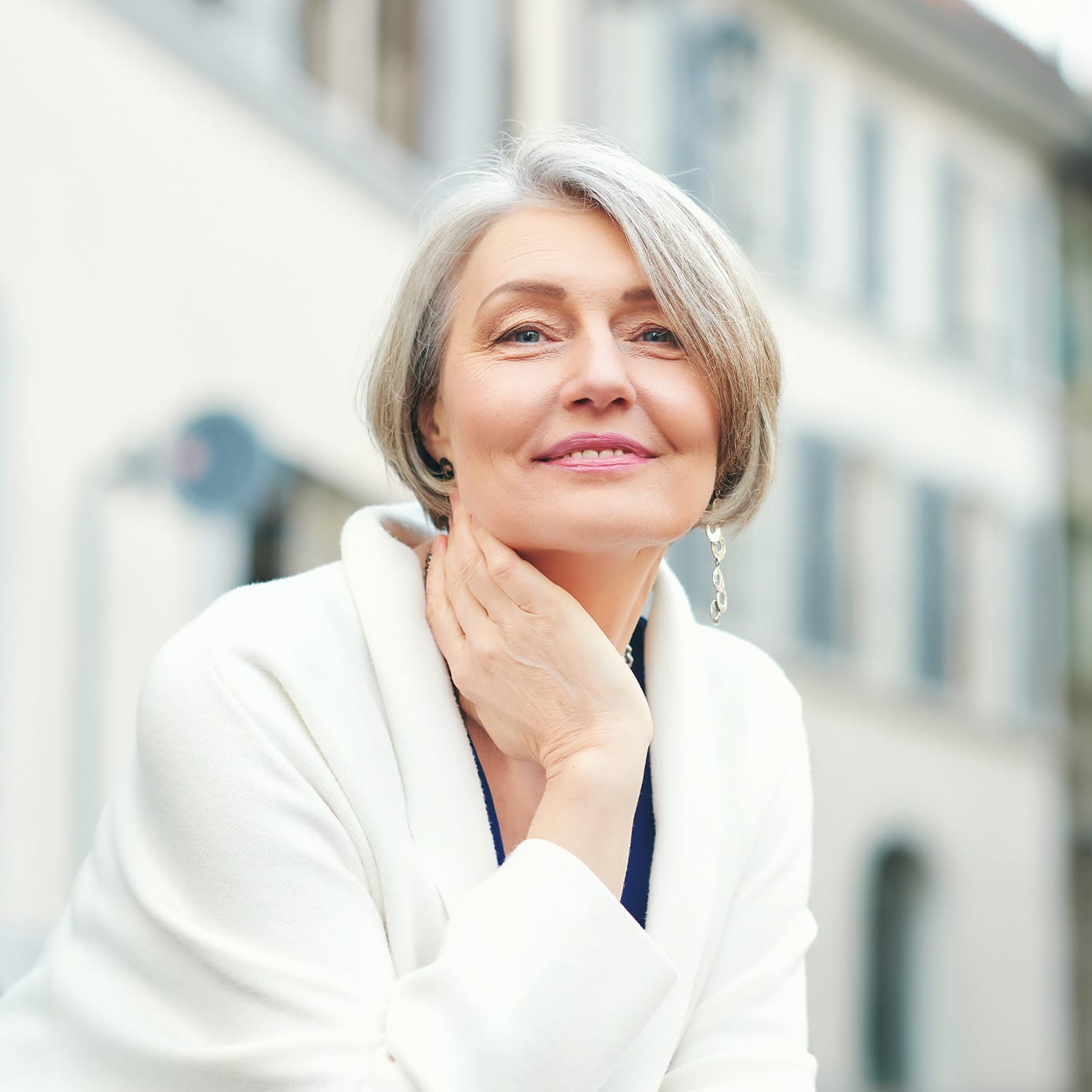 Woman in white coat smiling